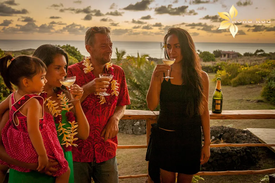 Family and friends enjoying drinks on a bungalow terrace at sunset, Kona Koa Eco Lodge.