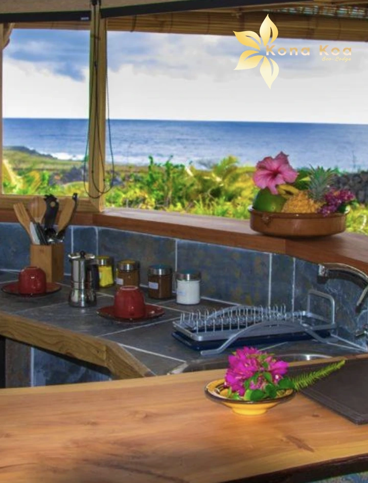 Kitchen corner of the Haka Nini bungalow with sink, crockery and sea view.