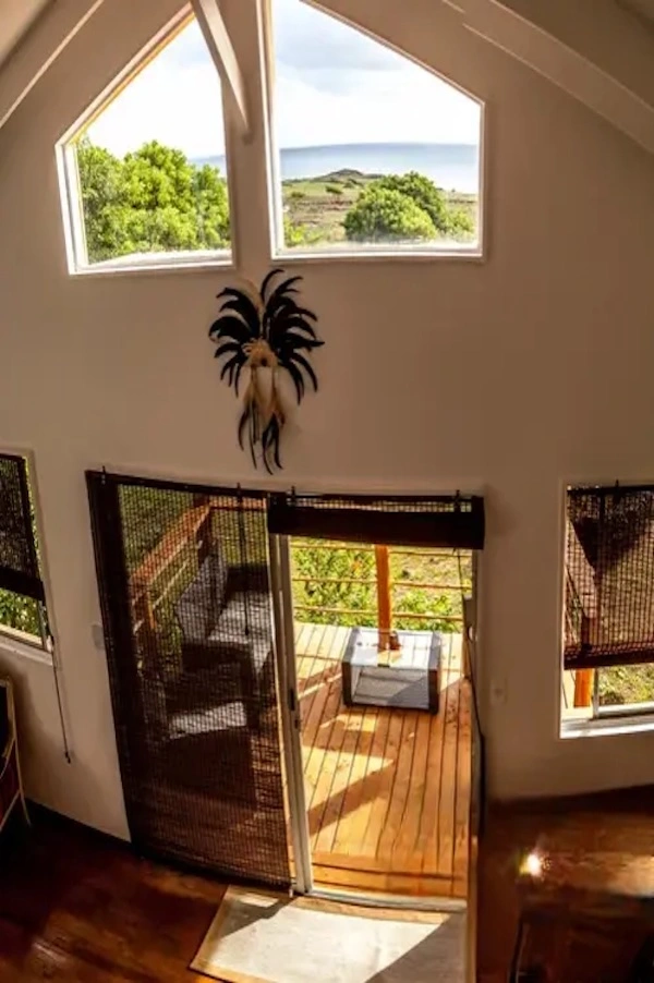Interior of the Haka Honu bungalow, windows opening onto the terrace and garden.