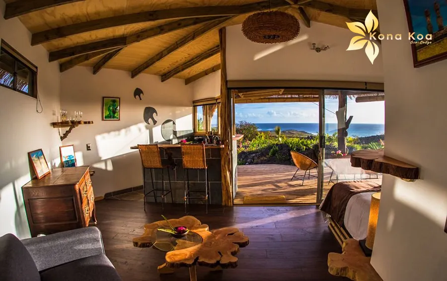 Bedroom of the Haka Nini bungalow with double bed and wooden wall decoration, Kona Koa Eco Lodge.