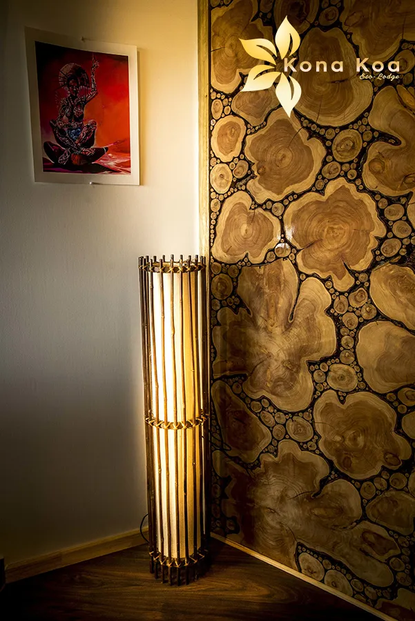 Decoration detail in a bungalow at Kona Koa Eco Lodge: wooden designer lamp and local art.