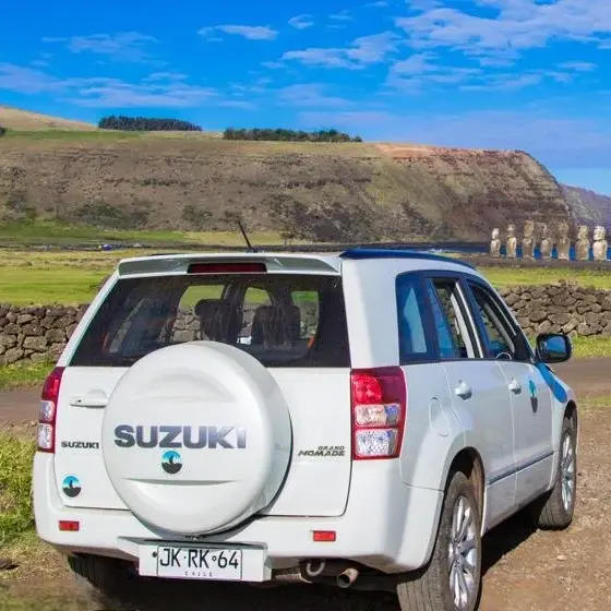 White Suzuki Gran Nomad rental car in front of the Tongariki moai.